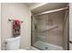 Bathroom featuring tiled walk-in shower with glass door, tiled accent border and safety grab bar at 315 Leisure World --, Mesa, AZ 85206