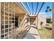 Inviting covered patio with a trellised roof, leading to the front door and a landscaped yard at 315 Leisure World --, Mesa, AZ 85206