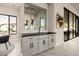 Modern bar area with gray cabinets, a sink, and a pass-through window at 3392 E Gemini Ct, Chandler, AZ 85249