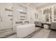 Bright bathroom featuring a soaking tub, glass shower, dual vanities, and stylish lighting for a modern design at 3392 E Gemini Ct, Chandler, AZ 85249