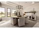 Dining area with a round wood table, modern chandelier, and ample natural light at 3392 E Gemini Ct, Chandler, AZ 85249