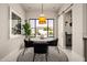 Bright dining nook with contemporary furniture, stylish pendant light and view to pool at 3392 E Gemini Ct, Chandler, AZ 85249