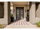 Front door with black planters and elegant decor at 3392 E Gemini Ct, Chandler, AZ 85249