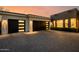 Modern garage with sleek doors, complemented by stone accents and a well-maintained paver driveway at 3392 E Gemini Ct, Chandler, AZ 85249