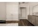 Bright hallway with hardwood floors and a double door closet, plus a decorative cabinet at 3392 E Gemini Ct, Chandler, AZ 85249