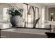 A close-up of a kitchen island featuring a sink, faucet, and floral arrangement at 3392 E Gemini Ct, Chandler, AZ 85249