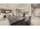 An open-concept space showing a kitchen island with a farmhouse sink, connecting to the living and dining areas at 3392 E Gemini Ct, Chandler, AZ 85249