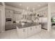 A modern kitchen with stainless steel appliances, a statement chandelier, and ample cabinet space at 3392 E Gemini Ct, Chandler, AZ 85249