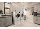 Well-organized laundry room boasts modern appliances, ample storage cabinets, a sink, and a stylish rug for added comfort at 3392 E Gemini Ct, Chandler, AZ 85249