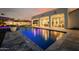 Beautiful swimming pool reflecting the twilight sky, featuring an elegant patio and outdoor seating area for entertaining at 3392 E Gemini Ct, Chandler, AZ 85249