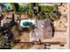 Aerial view of a home with a sparkling blue pool and solar panels on the roof at 3419 E Cholla St, Phoenix, AZ 85028