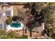 Aerial view of a sparkling in-ground pool and the home's yard with mature trees at 3419 E Cholla St, Phoenix, AZ 85028