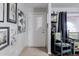 Inviting foyer with decorative art and tile flooring leads to an antique-styled clock at 3419 E Cholla St, Phoenix, AZ 85028