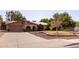 Charming single-story home featuring a well-manicured front yard, arched entryway and solar panels at 3419 E Cholla St, Phoenix, AZ 85028