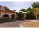 Charming home with desert landscaping, stone accents, solar panels, and cozy outdoor seating area at 3419 E Cholla St, Phoenix, AZ 85028