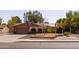 Inviting front exterior with a two-car garage, desert landscaping, and solar panels for energy efficiency at 3419 E Cholla St, Phoenix, AZ 85028