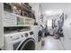 Well-organized laundry room with shelving, modern washer and dryer, and ample storage space at 3419 E Cholla St, Phoenix, AZ 85028