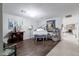 Spacious living room with hardwood floors, white piano, bar cabinet, and neutral paint at 3419 E Cholla St, Phoenix, AZ 85028