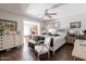 Spacious primary bedroom featuring a ceiling fan, wood floors, and an attached office at 3419 E Cholla St, Phoenix, AZ 85028