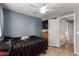 This bedroom has tile floors, a ceiling fan, and an egress to the hallway at 3424 E Flamingo Ct, Gilbert, AZ 85297