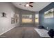 Bright bedroom with large windows, plush carpeting, and a modern blue accent wall at 3424 E Flamingo Ct, Gilbert, AZ 85297