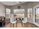 Bright dining area with modern white chairs, decorative wreath and plenty of natural light at 3424 E Flamingo Ct, Gilbert, AZ 85297