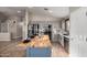 Bright kitchen showcasing gray cabinets, black appliances, an island with butcher block top, and wood-look tile flooring at 3424 E Flamingo Ct, Gilbert, AZ 85297