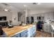 Open kitchen area with a large butcher block island, gray cabinets, and stainless steel appliances at 3424 E Flamingo Ct, Gilbert, AZ 85297