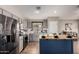 Modern kitchen featuring stainless steel appliances, gray cabinets, and a butcher block island with stylish blue base at 3424 E Flamingo Ct, Gilbert, AZ 85297