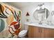 Bathroom features an updated vanity, colorful shower curtain, and stylish mirror at 3737 E Turney Ave # 206, Phoenix, AZ 85018