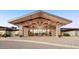 Elegant community clubhouse entrance with stone pillars and expansive windows at 39174 N Kaden Ln, San Tan Valley, AZ 85140