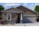 A cozy single-story house showcasing stone veneer, a two-car garage, and neutral color scheme at 4038 E San Jose St, San Tan Valley, AZ 85143