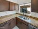 Kitchen area featuring granite countertops and a stainless steel sink beneath a window at 4216 S 100Th Dr, Tolleson, AZ 85353