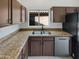 Functional kitchen featuring granite countertops, stainless steel appliances, and ample dark wood cabinetry at 4216 S 100Th Dr, Tolleson, AZ 85353