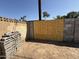 Backyard featuring a newly boarded up section of the block fence and ample space at 4221 N 33Rd Dr, Phoenix, AZ 85017