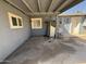 Exterior carport area with visible damage, water heater, and various wall fixtures at 4221 N 33Rd Dr, Phoenix, AZ 85017