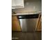 Amana stainless steel dishwasher, surrounded by countertops and wood cabinets, in need of repair at 4221 N 33Rd Dr, Phoenix, AZ 85017