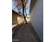 Narrow side yard with dirt, a small tree, and fencing between properties at 4221 N 33Rd Dr, Phoenix, AZ 85017