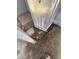 Base of a water heater unit showing debris, dirt, and surrounding exterior elements at 4221 N 33Rd Dr, Phoenix, AZ 85017