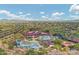 Aerial view of community center with pool, waterpark, desert landscaping, and mountain views at 42424 N Gavilan Peak Pkwy # 30104, Anthem, AZ 85086