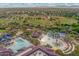 Aerial view of a recreational park featuring baseball fields, swimming pools, and a playground at 42424 N Gavilan Peak Pkwy # 30104, Anthem, AZ 85086