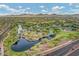 Breathtaking aerial view of the community pond, playground, and common green spaces with mountain views at 42424 N Gavilan Peak Pkwy # 30104, Anthem, AZ 85086