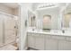 Bright bathroom featuring a double sink vanity and glass-enclosed shower at 42424 N Gavilan Peak Pkwy # 30104, Anthem, AZ 85086