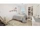 Bright bedroom with a cozy bed, decorative rug, and built-in shelving at 42424 N Gavilan Peak Pkwy # 30104, Anthem, AZ 85086