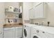 Convenient laundry room equipped with a washer, dryer, and storage cabinets at 42424 N Gavilan Peak Pkwy # 30104, Anthem, AZ 85086