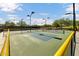 Outdoor pickleball court featuring a green surface, black fence and nets with clear blue skies at 42424 N Gavilan Peak Pkwy # 30104, Anthem, AZ 85086