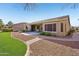 View of the home's well-maintained backyard with artificial grass and desert landscaping at 42808 W Whimsical Dr, Maricopa, AZ 85138