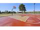 Outdoor basketball court with red and beige surface, neighborhood in background at 42808 W Whimsical Dr, Maricopa, AZ 85138