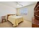 Bedroom with neutral carpet, a ceiling fan, and a built-in bookcase at 42808 W Whimsical Dr, Maricopa, AZ 85138