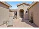 Inviting courtyard with brick flooring, seating, and a charming arched entryway into the home at 42808 W Whimsical Dr, Maricopa, AZ 85138